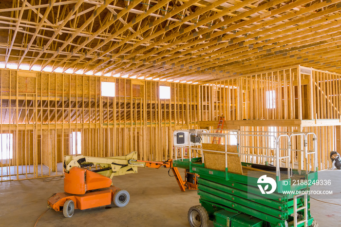 Contractor using boom truck forklift in construction site the under construction home framing beam