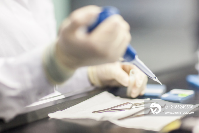 Preparation of samples under fume cabinets in order to analyse them in an Analytical Transmission Electron Microscope (ATEM), stage of positionning samples on grids, asbestos laboratory