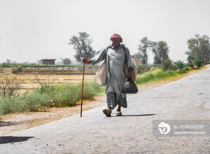 a villager is walking on a street cause of a transportation shortage