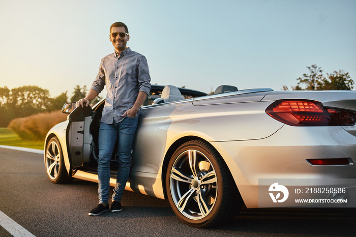 man standing at cabrio outdoors