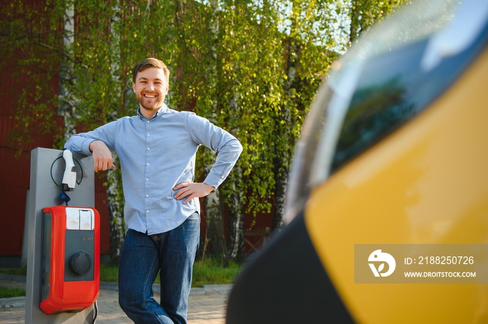 Man Holding Power Charging Cable For Electric Car.