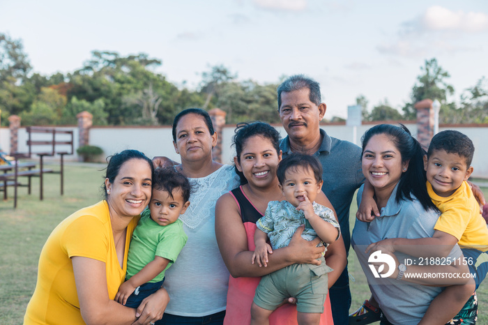 Latino family having fun in the park, everyone happy