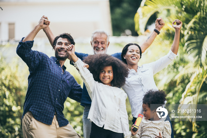 Multi-generation family having fun together outdoors