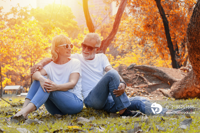 caucasian senior couple having romance moment together in park in autumn