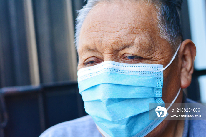 Old native american man wearing mask.