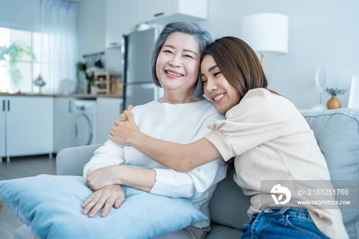 Portrait of Asian lovely family, young daughter hugging older mother.