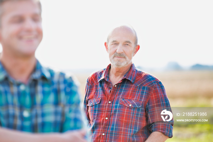 Senior farmer standing in field