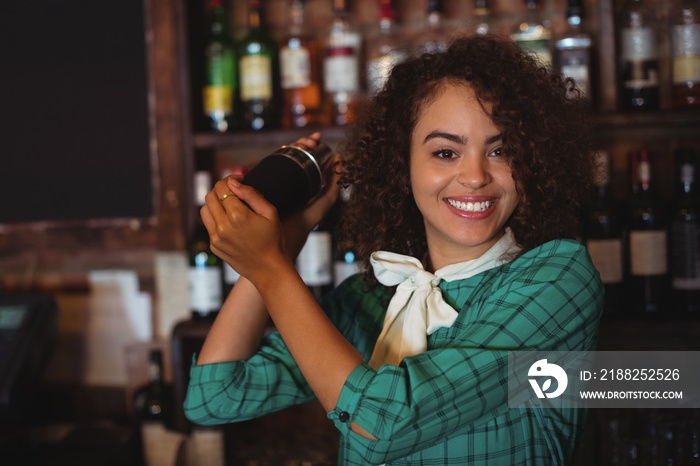 Portrait of female bartender mixing a cocktail drink