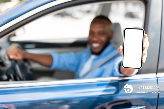 Happy driver using showing smartphone with white empty screen