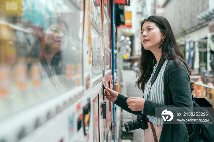 lady putting coins into the vendor machine