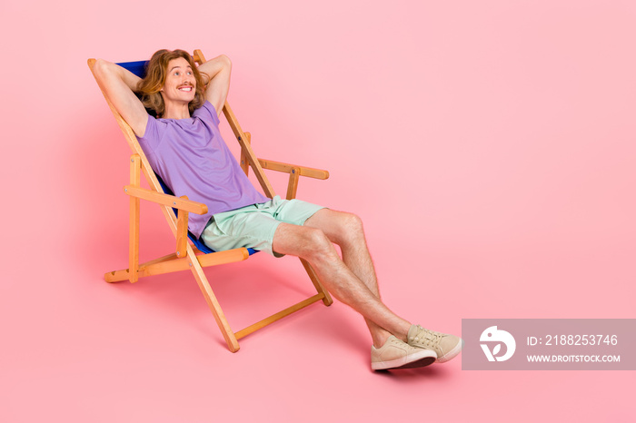 Full length body size view of attractive cheerful funky guy sitting in chair day off isolated over pink pastel color background