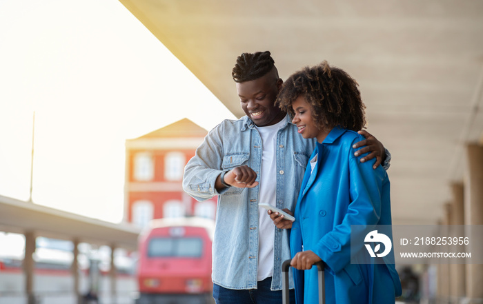 Portrait Of Happy Black Couple Waiting For Train At Railway Station