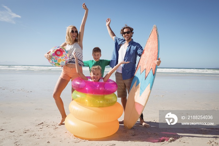 Cheerful family with arms raised at beach