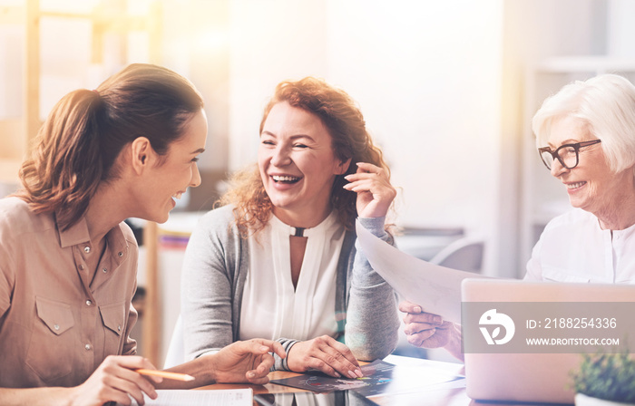 Emotional passionate colleagues laughing at joke