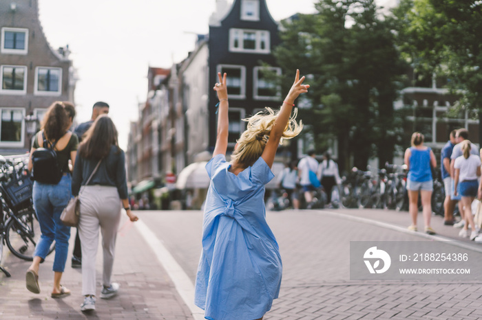 happy girl in blue dress in amsterdam.