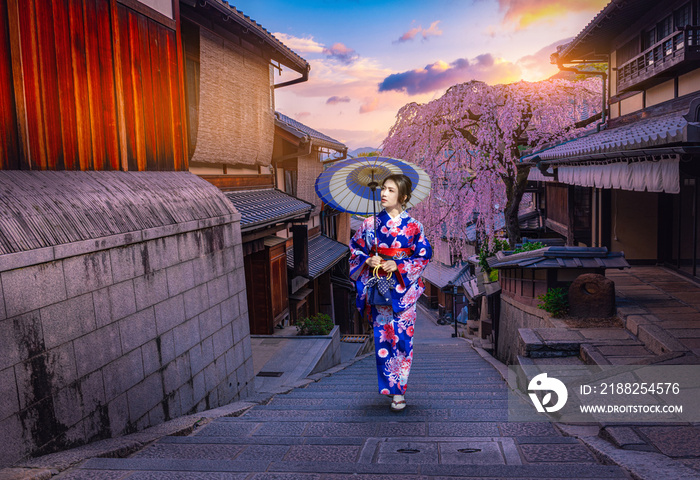 Young women in beautiful Japanese kimono dress enjoying  Historic Higashiyama district,  Kyoto in Japan.