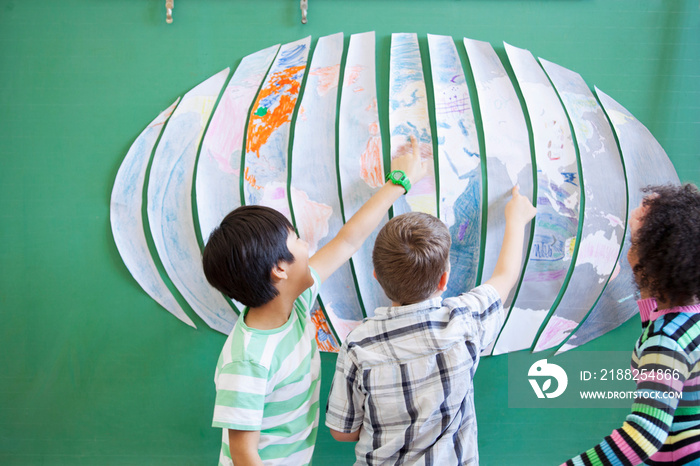 students looking at world map