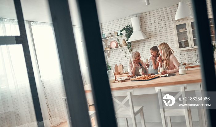 Daughter, mother and grandmother on kitchen