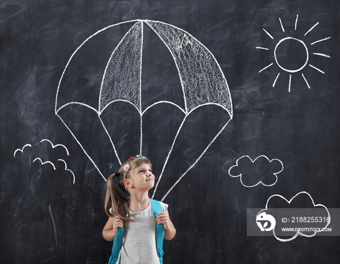 Schoolgirl flying with a parachute