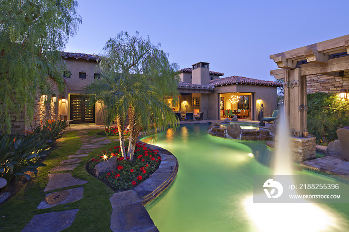 Shooting water outside House Exterior with swimming pool and hot tub