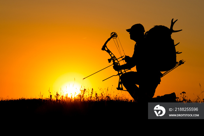 Silhouette of a bow hunter