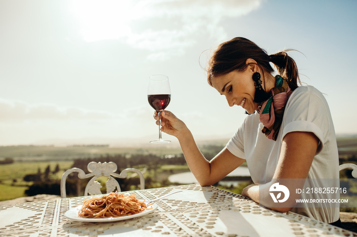 Portrait of a smiling woman drinking wine