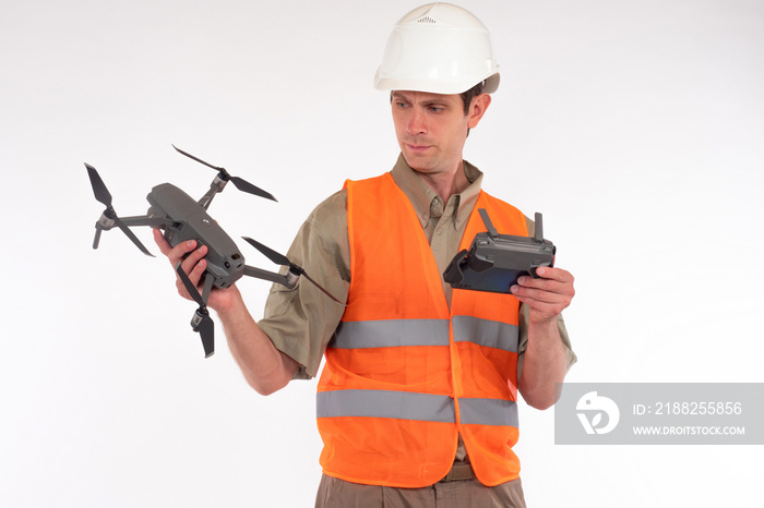 Surveyor engineer is holding a drone. surveyor engineer with quadcopter on white background. A concept builder uses a drone for topographic work. surveyor engineer holding a drone with a camera.