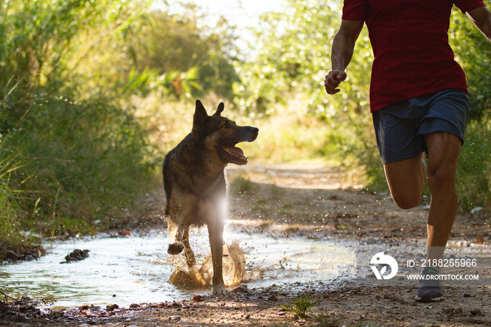 runner running across the field with his dog