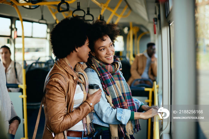 Happy African American women enjoying while traveling by bus.