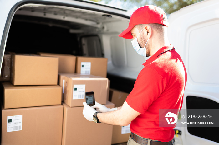 Delivery courier using a smartphone while delivering a parcel