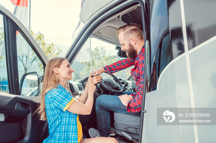 Man and woman testing a camper van or RV