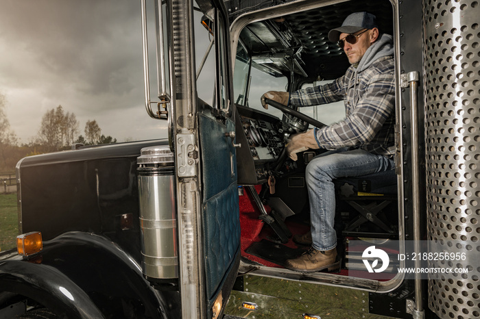 Caucasian Trucker Inside American Semi Truck Tractor