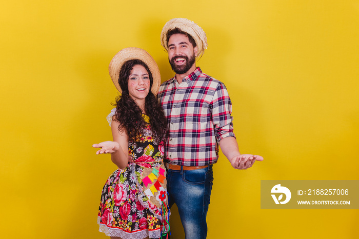 Beautiful couple dressed in typical clothes for a Festa Junina. Arraia de Sao Joao. Be welcome. welcoming.