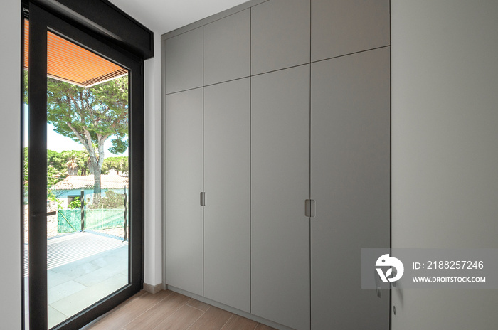 Built-in wardrobes design. Built-in empty wardrobes with open doors. New house, empty rooms.