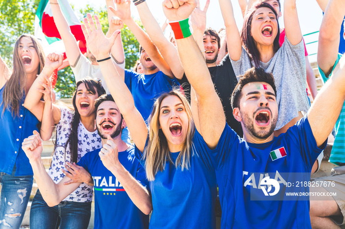 Italian supporters celebrating at stadium with flags