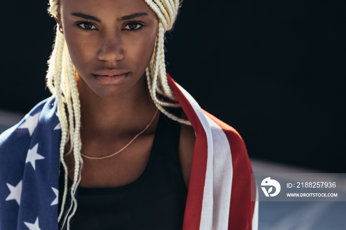 Female athlete with american flag on her back