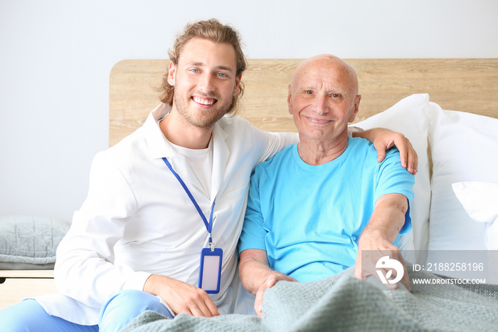 Doctor with elderly man in nursing home