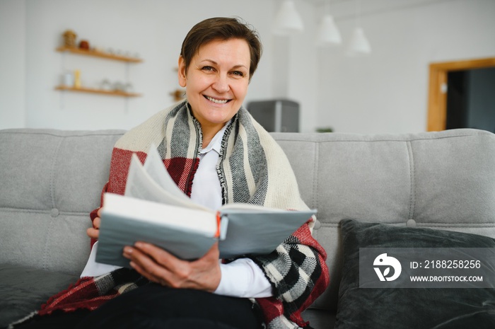 Portrait of senior woman reading book