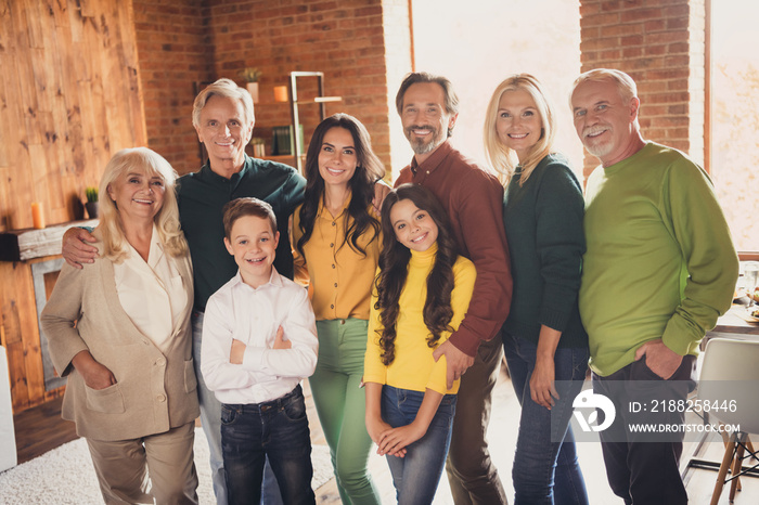 Photo of full family gathering eight people two small kids embrace cuddle long awaited relatives autumn season november traditional dinner generation in home evening living room indoors