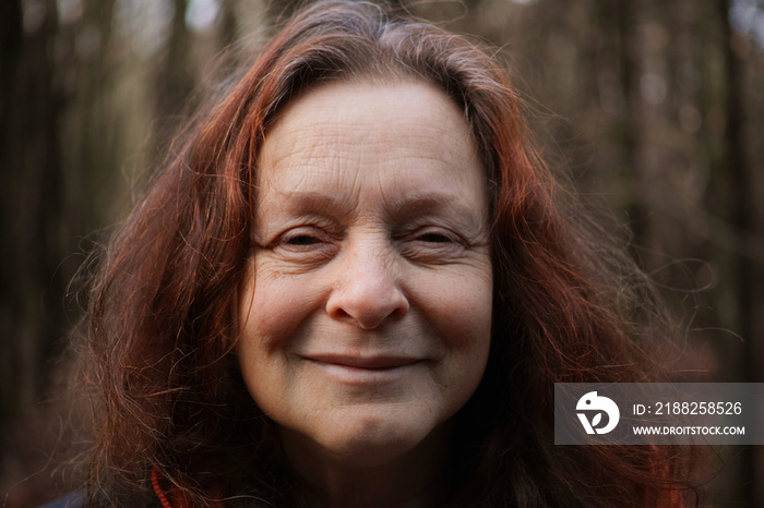 Portrait of a 60 year old smiling woman without make-up