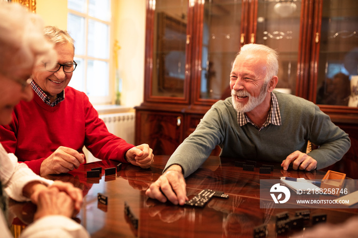 Older folks enjoying playing board games