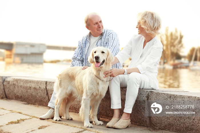 Senior couple and big dog on bund