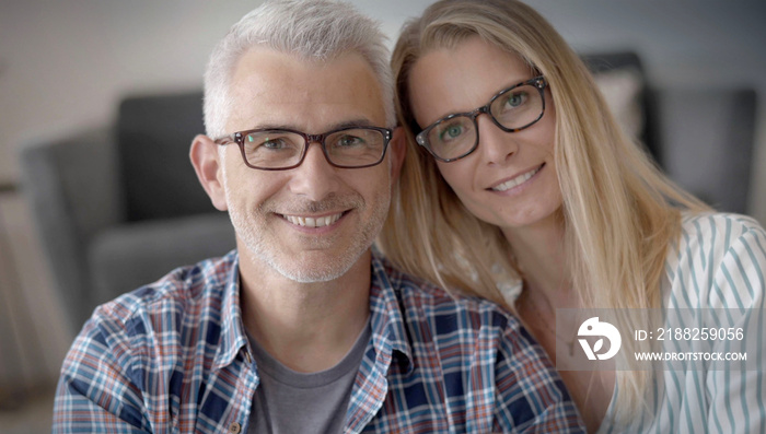 portrait of a 40 year old couple with glasses in their house