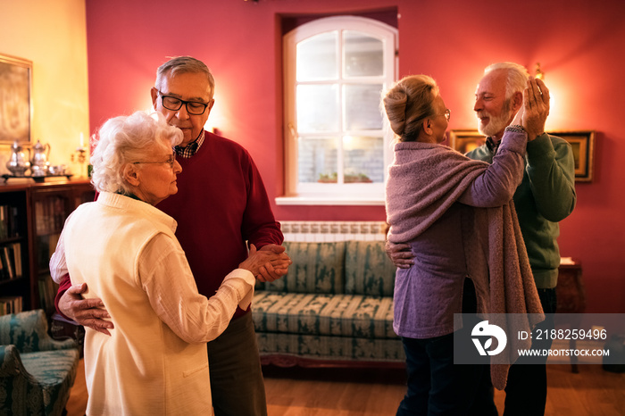 Two senior couple dancing and enjoy together at home