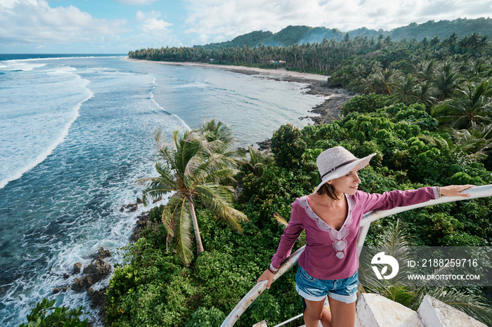 Yyoung woman enjoying tropical island view.