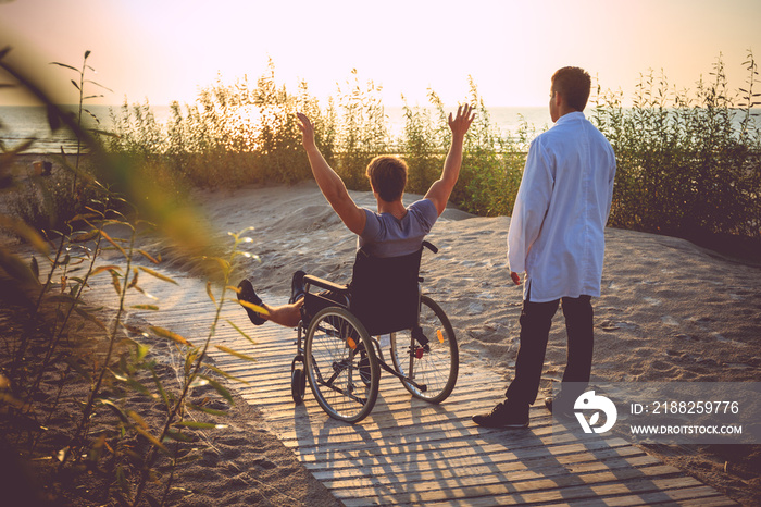 A man on wheelchair and his nurse.