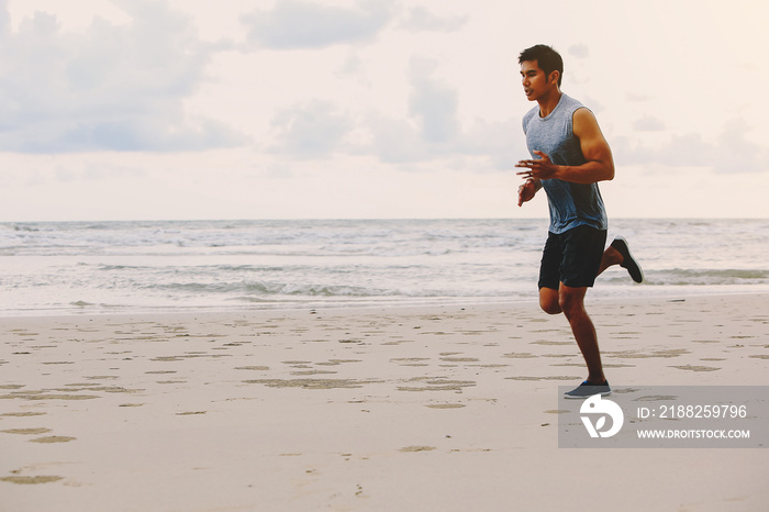 Runners. Young people running on beach. Athletic attractive people jogging on beach enjoying the sun exercising their healthy lifestyle.