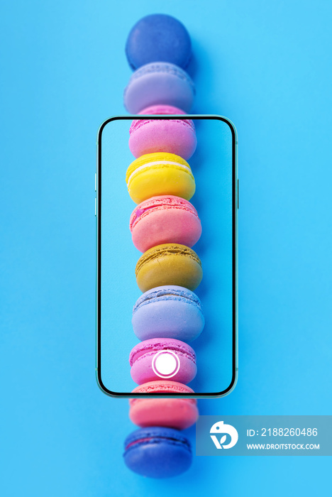 Food photo, food photography concept with French macarons in smartphone screen viewfinder. Vertical photography.