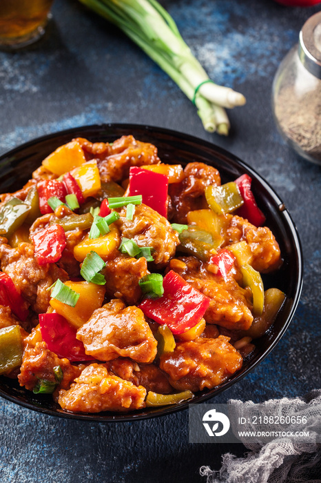 Sweet and sour chicken with colorful bell pepper on a plate