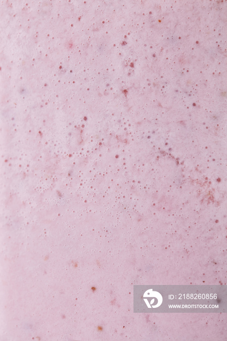 Macro photo of milky berry smoothie with bubbles. Food background